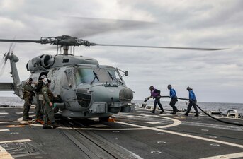 USS Rafael Peralta (DDG 115) refuels an MH-60R Sea Hawk helicopter  in the Philippine Sea.