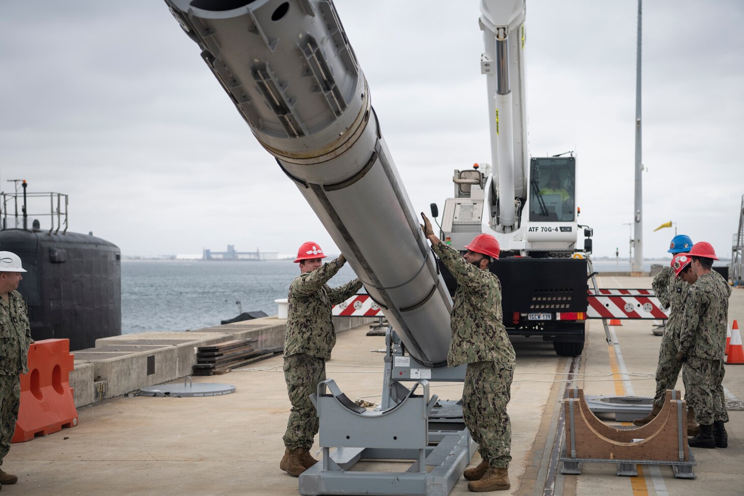 U.S. Navy Sailors assigned to the Virginia-class fast-attack submarine USS Mississippi (SSN 782), Sailors assigned to Navy Munitions Command East Asia Division (NMC EAD) unit Guam, Royal Australian Navy Sailors, and explosive ordnance support personnel from Thales Australia participate in a weapons-handling training exercise with a Tomahawk Land Attack Missile training shape at HMAS Stirling Navy Base on Garden Island, Dec. 1. Mississippi conducted expeditionary reload training at HMAS Stirling, Australia, to enhance interoperability and communication, and strengthen relationships with the Royal Australian Navy.