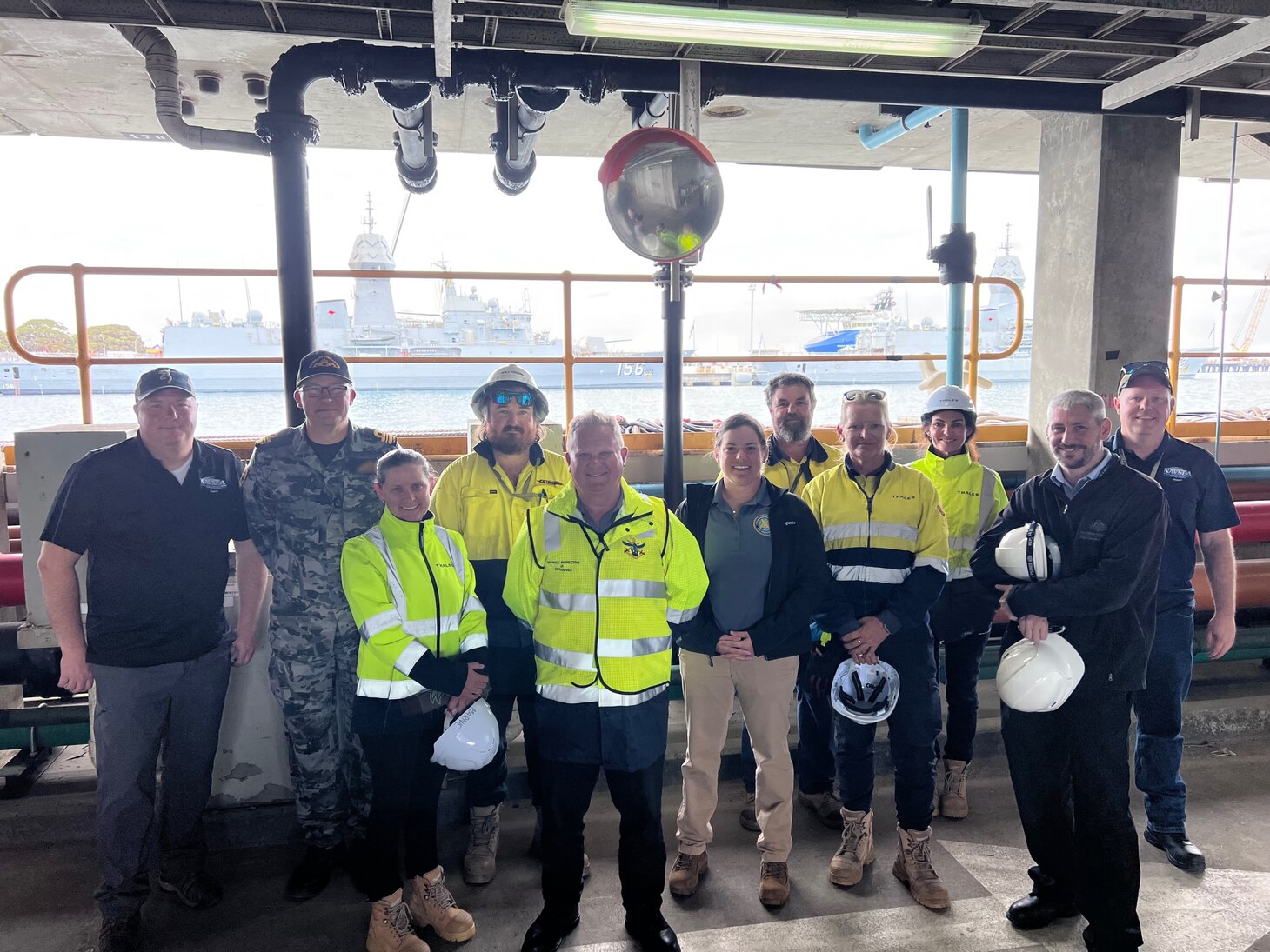 Marc Trei, left, and Mike Williams, right, from Naval Undersea Warfare Center (NUWC) Division, Keyport’s Countermeasure In-Service Engineering Agents (ISEA), pose for a photo with personnel from the Royal Australian Navy Submarine Force, explosive ordnance support personnel from Thales Australia, and Joint Explosive Ordnance Support-Western Australia personnel at HMAS Stirling Navy Base on Garden Island, Dec. 2. NUWC Keyport personnel were in Australia supporting the Virginia-class fast-attack submarine USS Mississippi (SSN 782) expeditionary reload training at HMAS Stirling to enhance interoperability and communication, and strengthen relationships with the Royal Australian Navy.