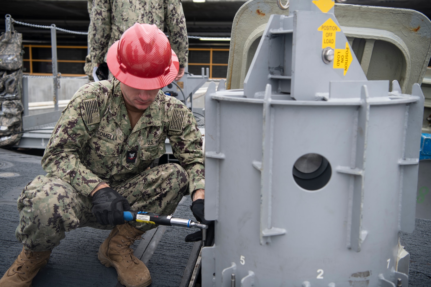 Mineman 3rd class Nicholas Comella, assigned to Navy Munitions Command East Asia Division (NMC EAD) Unit Guam, works aboard the Virginia-class fast-attack submarine USS Mississippi (SSN 782) during a weapons-handling training exercise with a Tomahawk Land Attack Missile training shape while moored at HMAS Stirling Navy Base on Garden Island, Dec. 1. Mississippi conducted expeditionary reload training at HMAS Stirling, Australia, to enhance interoperability and communication, and strengthen relationships with the Royal Australian Navy.