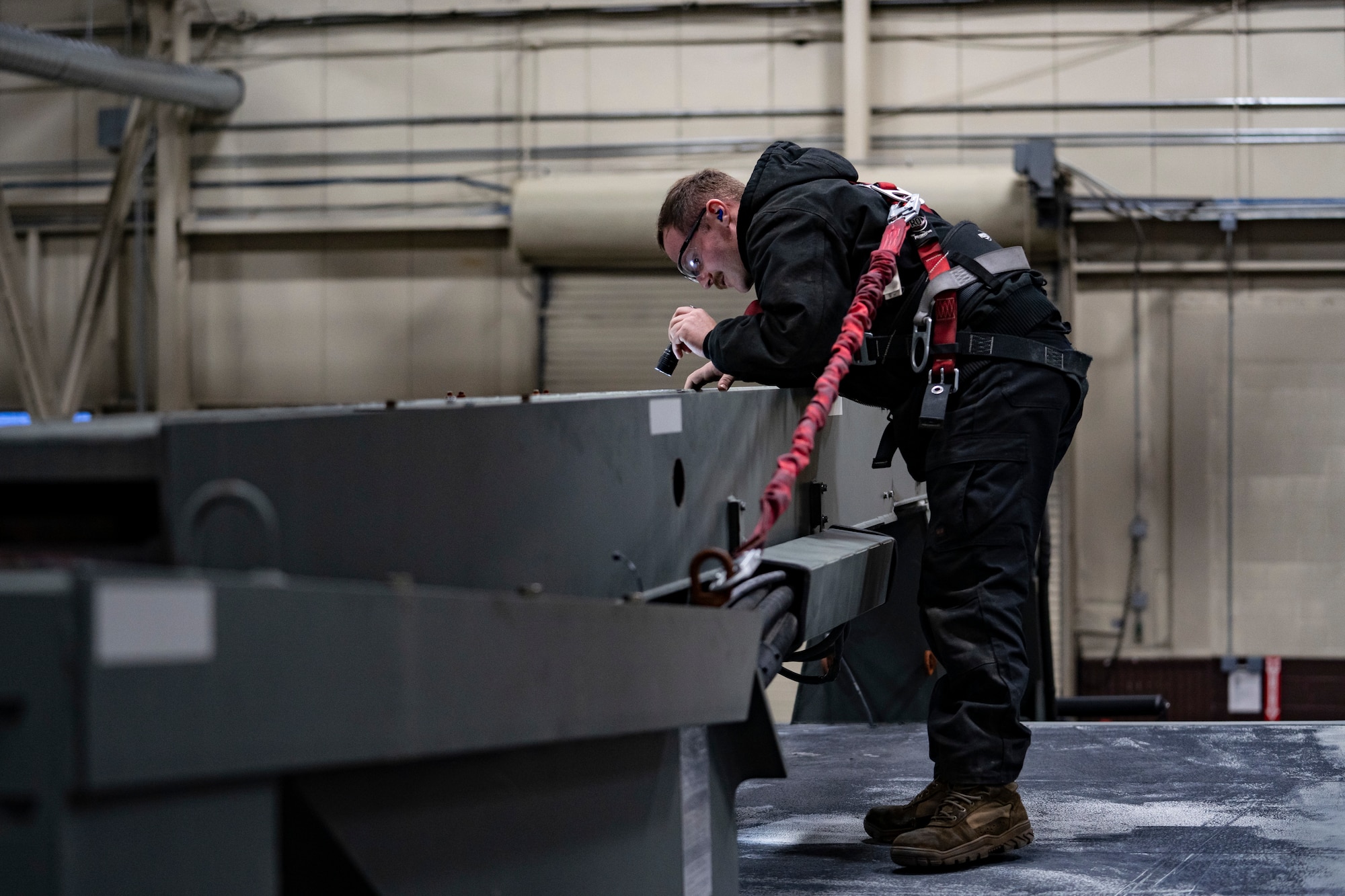 U.S Air Force Staff Sgt. Clayton Postlethwait, the 673d Logistics Readiness Squadron non-commissioned officer in charge of Flight Line maintenance, performs a quality check on boom repairs made to a 1800 Global Deicer at Joint Base Elmendorf Richardson, Alaska, Oct. 28, 2022.