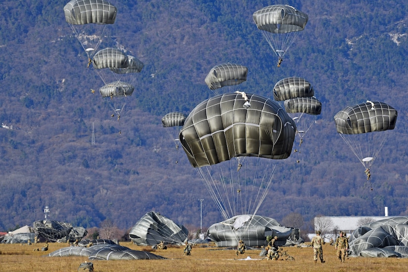 U.S. paratroopers jump from a C-130 Hercules aircraft over Juliet drop zone  in Pordenone, Italy