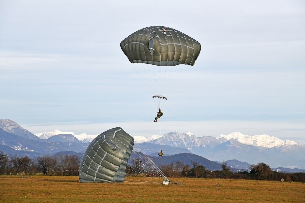 Paratroopers land on the ground.