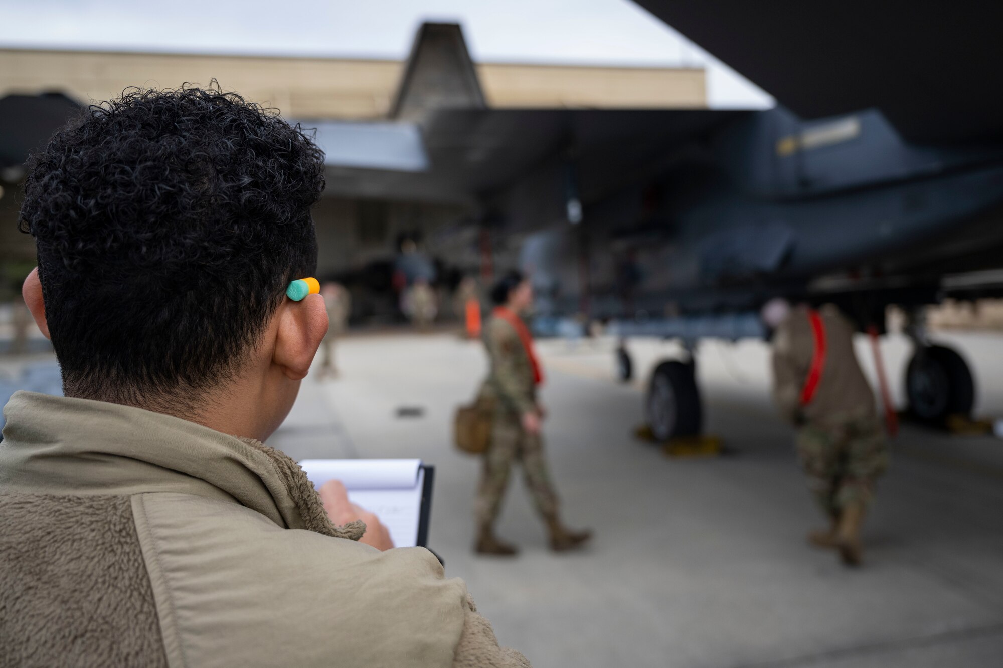 Senior Airman Miguel Guance, 4th Maintenance Group weapons safety load crew member, evaluates members of the 333rd Fighter Generation Squadron during the 4th Quarter Weapons Load Crew Competition at Seymour Johnson Air Force Base, North Carolina, Jan. 13, 2023. The competition was held to recognize the hard work and dedication of weapons load crews while ensuring that they are mission ready