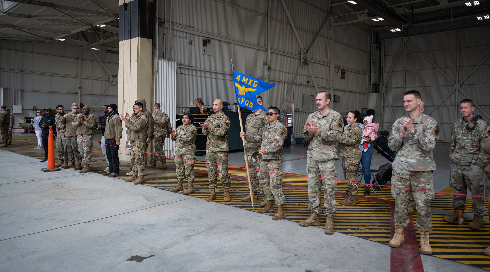 Members of the 4th Maintenance Group cheer on their squadrons during a quarterly load crew competition at Seymour Johnson Air Force Base, North Carolina, Jan. 13, 2023. During the competition, crews were required to follow checklists to ensure the weapons were assembled and installed safely and correctly.