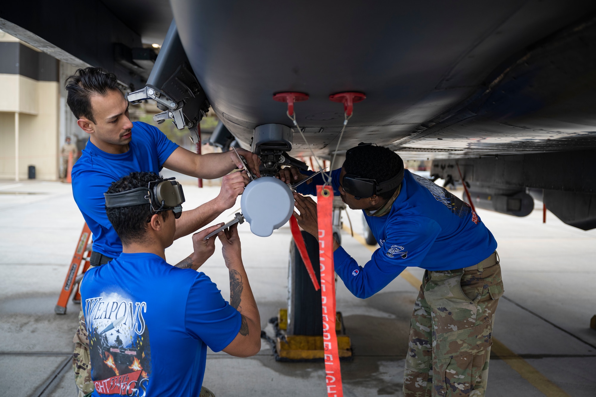 Airmen assigned to the 334th Fighter Generation Squadron attach parts to a weapon during the 4th Quarter Weapons Load Crew Competition at Seymour Johnson Air Force Base, North Carolina, Jan. 13, 2023. The load crews were given one hour to complete the competition, but faster crews were awarded more points