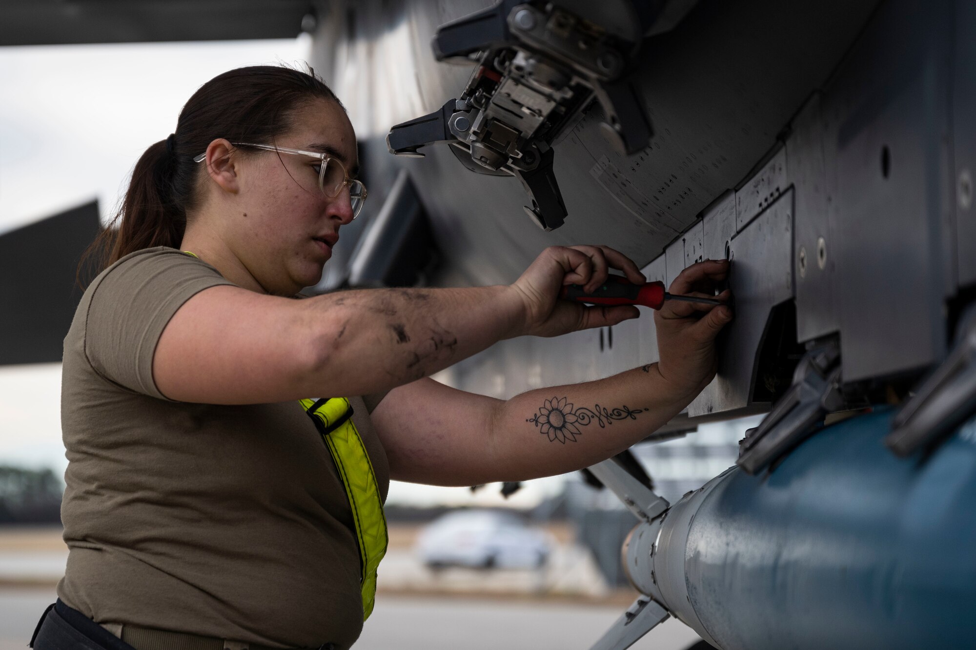 An Airman assigned to the 336th Fighter Generation Squadron tightens a screw on an F-15E Strike Eagle during the 4th Quarter Weapons Load Crew Competition at Seymour Johnson Air Force Base, North Carolina, Jan. 13, 2023. The crews were responsible for ensuring the munitions were safe, properly configured and serviceable.
