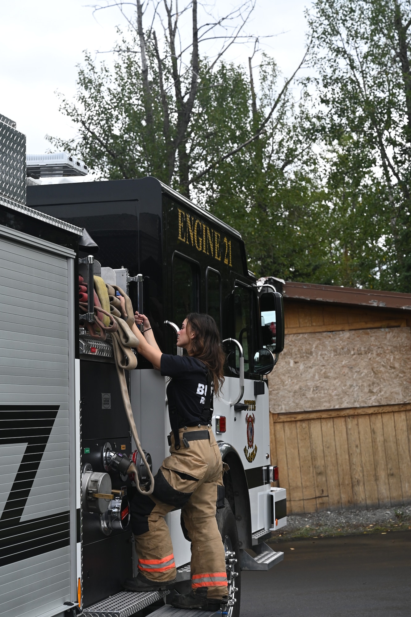 1st Lt. Kaitlyn Lawton, 477th Fighter Group Public Affair officer, repacks a hose bed following a joint firefighter and emergency medical services exercise in the Palmer, Alaska. Lawton is a fire fighter for the Butte Fire Department in the Matanuska-Susitna Borough, Alaska.