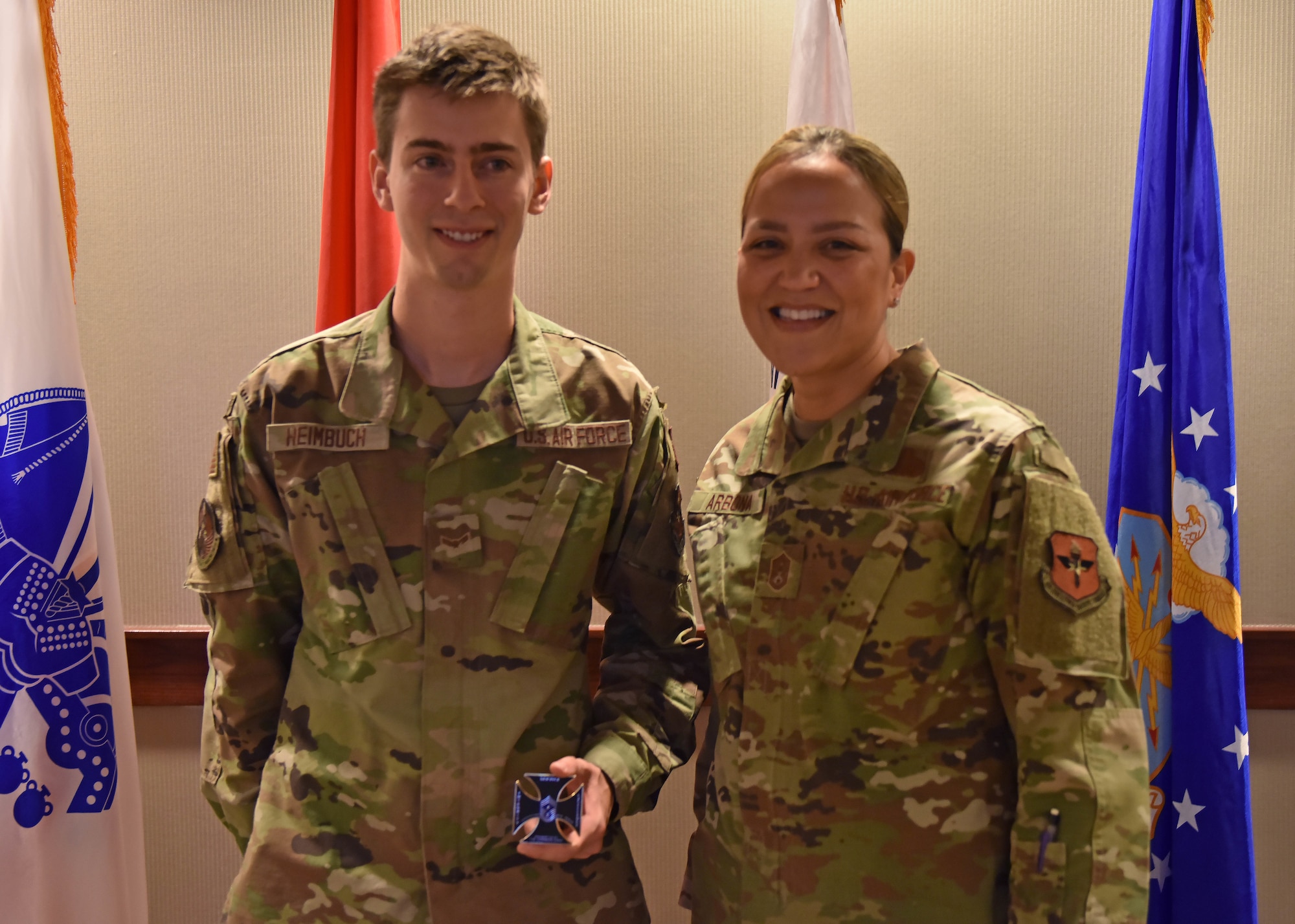 U.S. Air Force Airman 1st Class Zachary Heimbuch, 17th Training Wing Public Affairs specialist displays a coin given to him by Chief Master Sgt. Rebecca Arbona, 17th TRW command chief at Goodfellow Air Force Base, Texas, Jan. 18, 2023. Heimbuch was recognized at wing staff meeting for his positive mental attitude and hard work at the PA office. (U.S. Air Force photo by Senior Airman Ethan Sherwood)