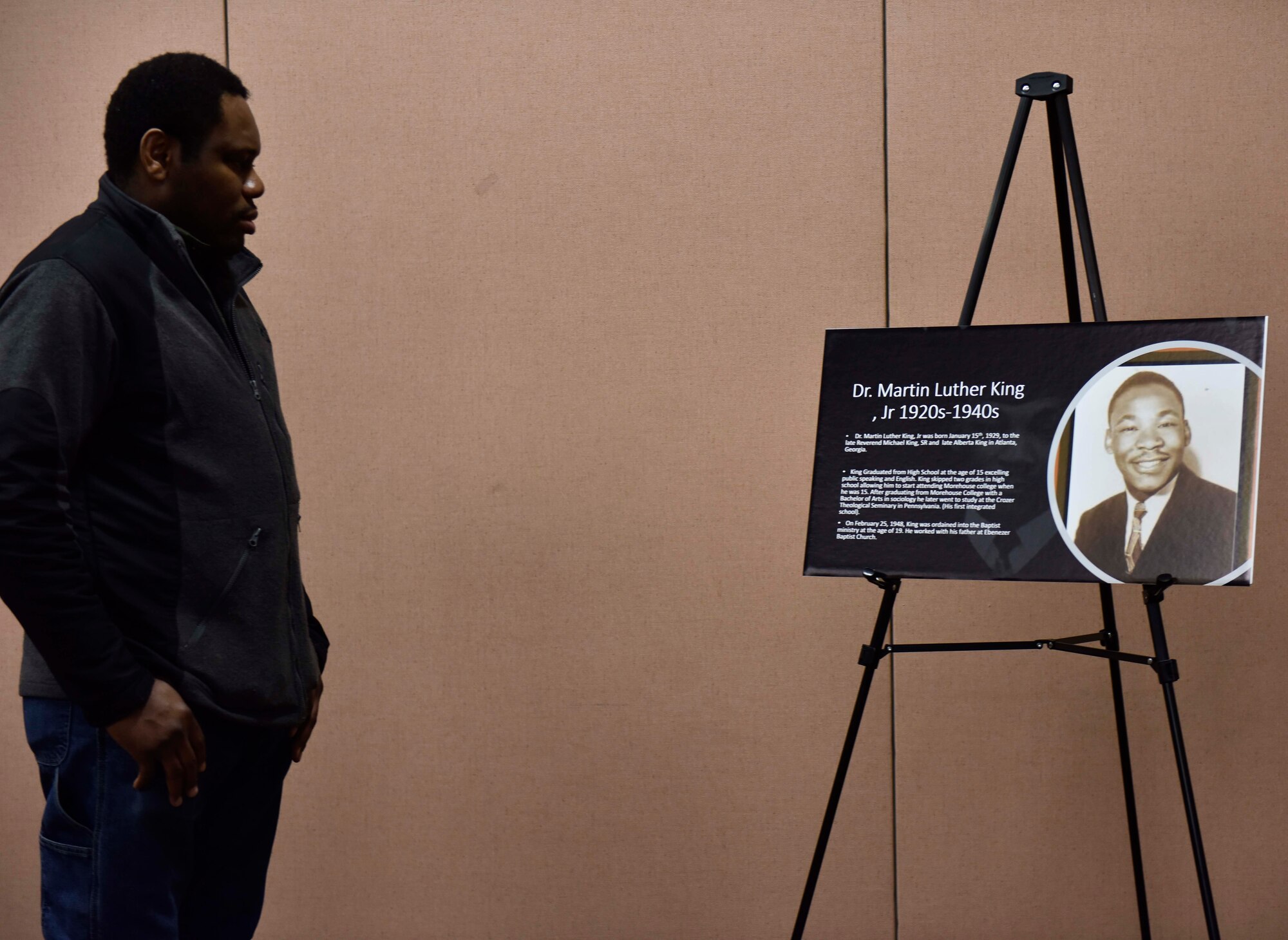An attendee during the Dr. Martin Luther King Jr. celebration views a poster of King’s early life on Beale Air Force Base, Jan. 13, 2023.