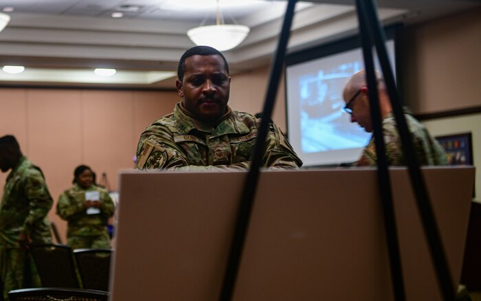 U.S. Air Force Master Sgt. Marques Bones, 9th Force Support Squadron Airman development advisor, reads a poster at the Recce Point Club on Beale Air Force Base on Jan. 13, 2023.