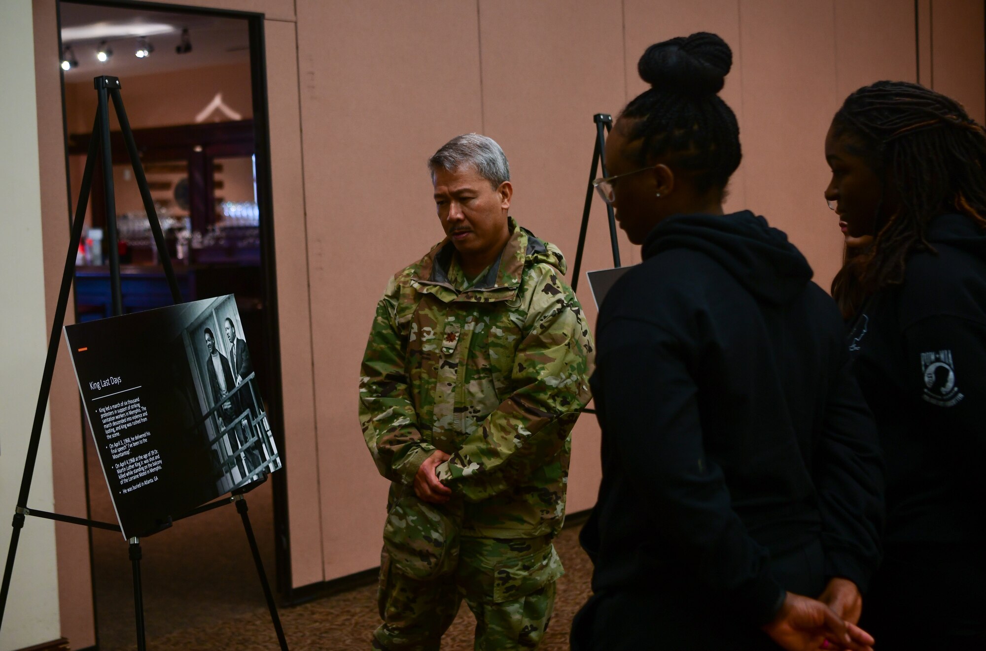 Attendees read posters at the Recce Point Club on Beale Air Force Base on Jan. 13, 2023.