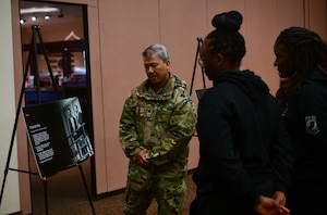 Attendees read posters at the Recce Point Club on Beale Air Force Base on Jan. 13, 2023.