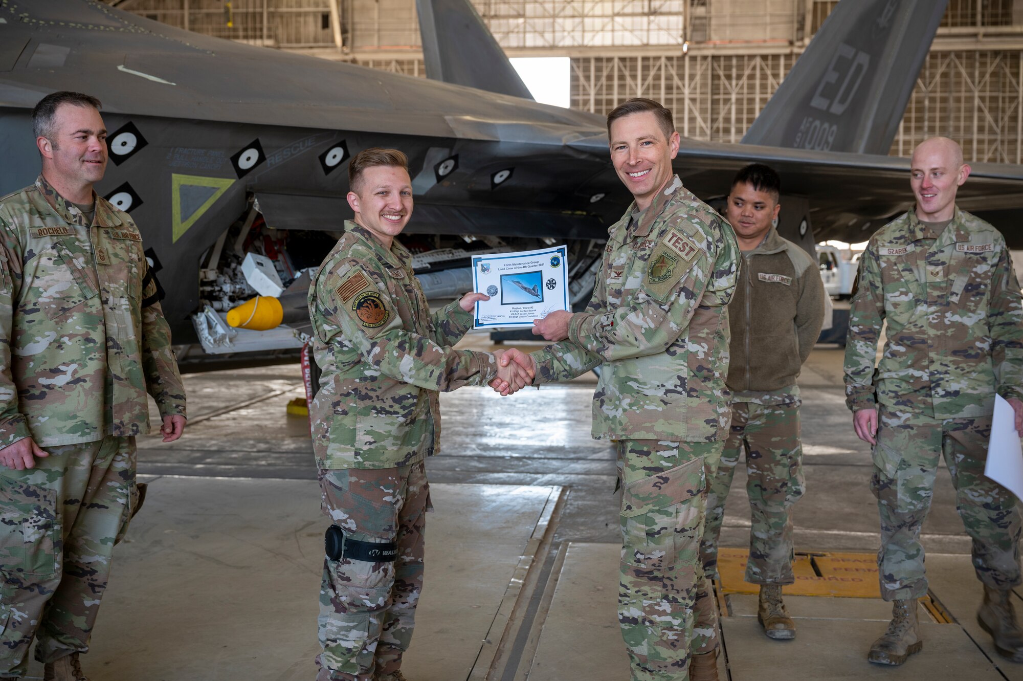 The 411th Raptor AMU wins the 3rd Quarter Weapons Load Crew of the Quarter Competition. (Pictured: Col. Matthew Caspers, Vice Commander, 412th Test Wing)