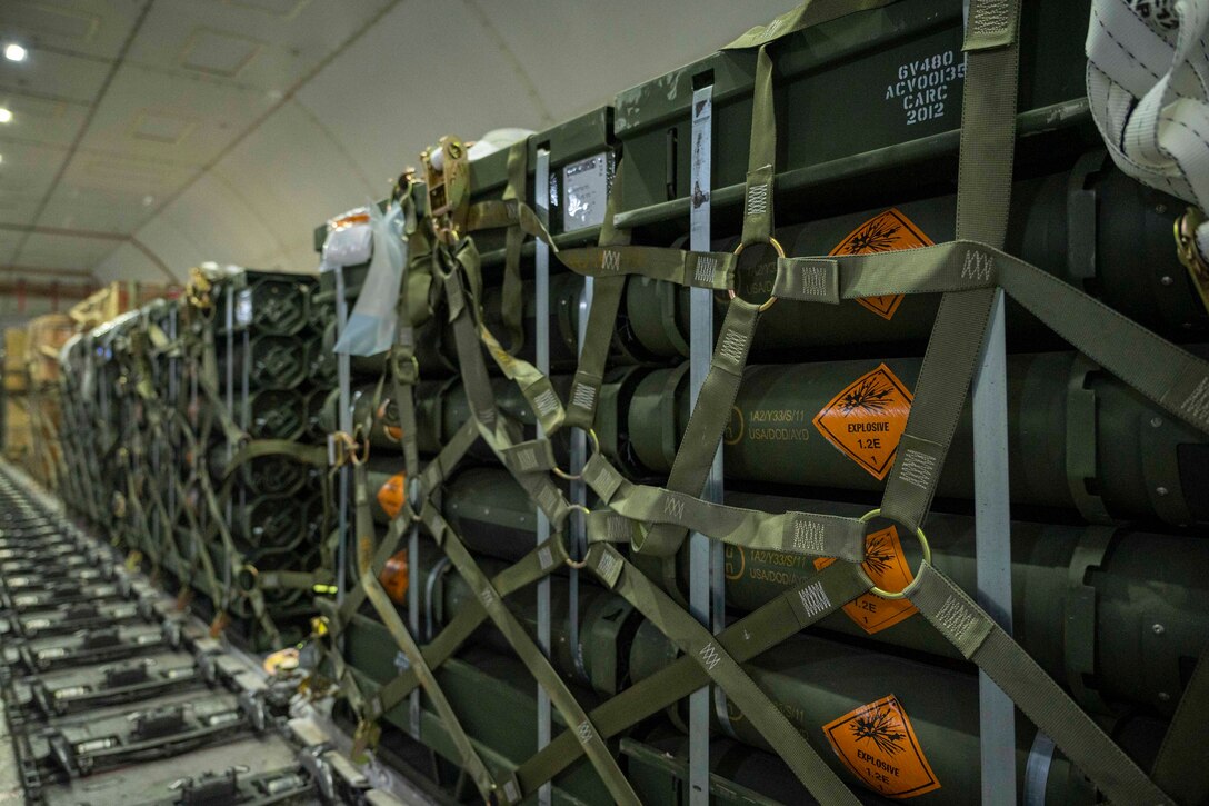 Pallets of ammunition sit inside a cargo plane.
