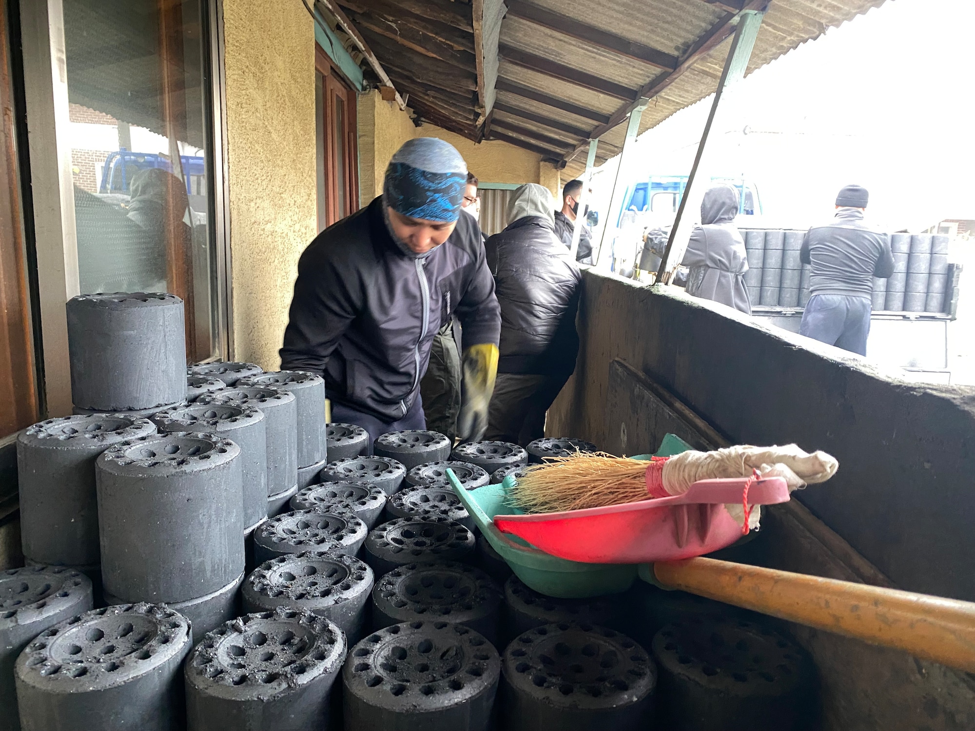 An 8th Fighter Wing Airman grabs a coal brick during a community coal run in Gunsan City, Republic of Korea, Jan. 14, 2023. Many Gunsan homes are traditional and use coal as the primary source of heat to keep warm during the Winter season. (U.S. Air Force photo by Tech. Sgt. Timothy D. Dischinat)