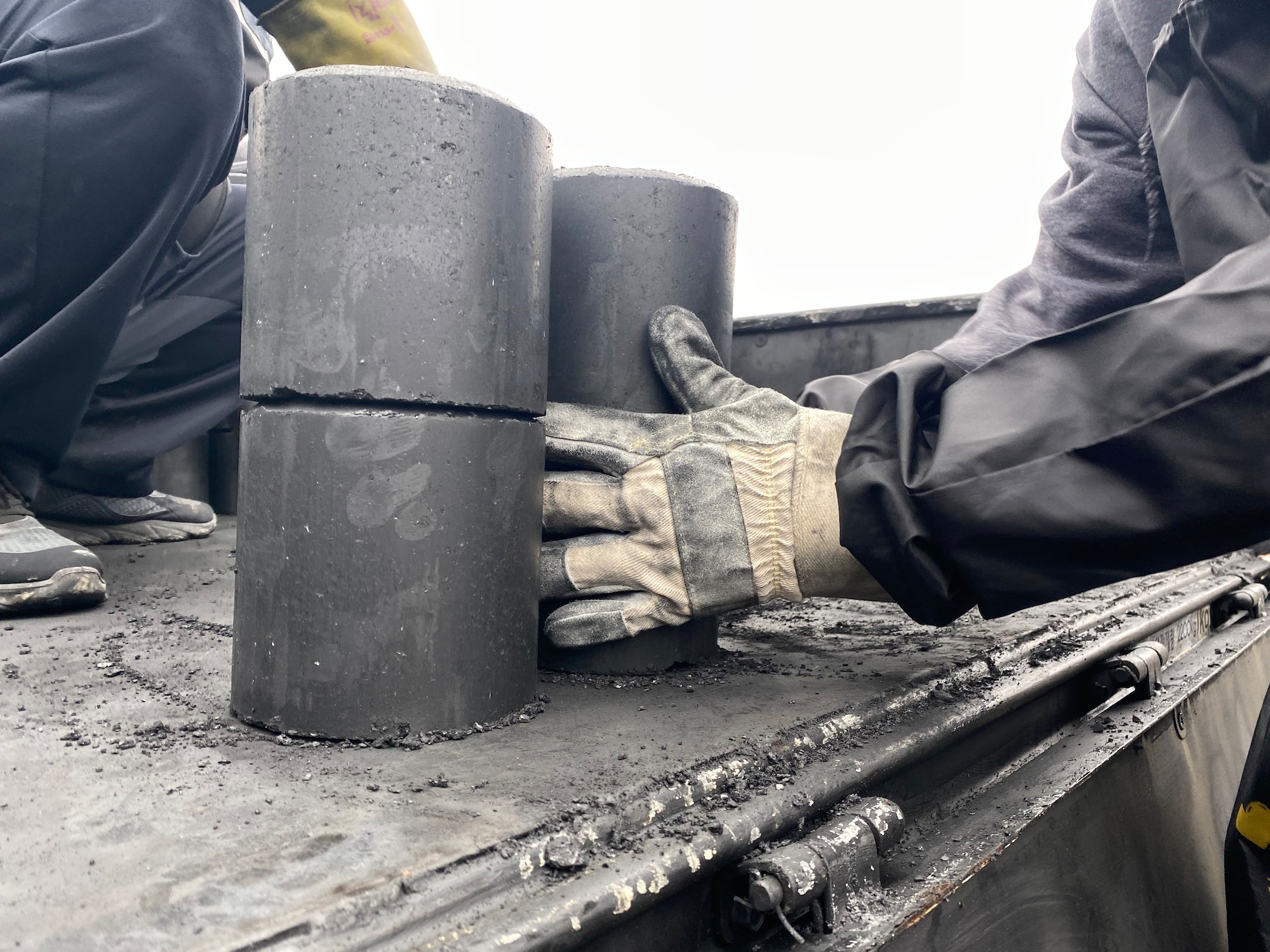 An Airman picks up coal bricks during a community coal run in Gunsan City, Republic of Korea, Jan. 14, 2023. Kunsan worked with the local community to help distribute coal to help keep the community warm and foster relations between the installation and the local community. (U.S. Air Force photo by Tech. Sgt. Timothy D. Dischinat)