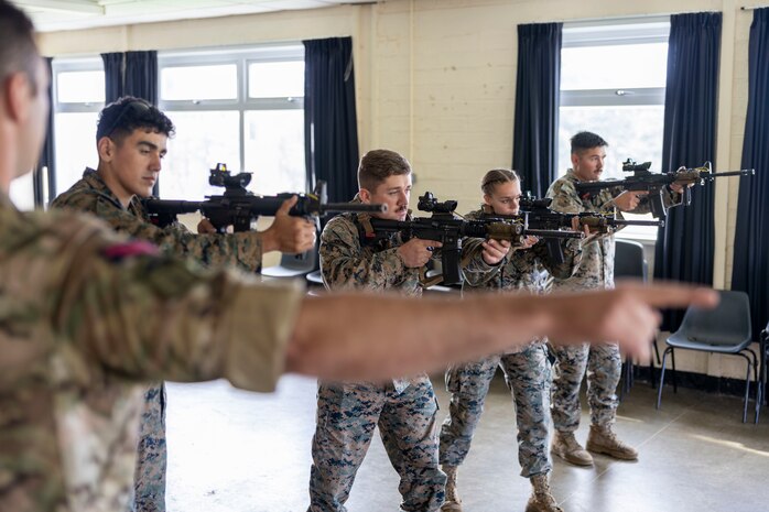 British Royal Marine Cpl. Charlie Walker, a GD training corporal with 43 Commando Fleet Protection Group Royal Marines, conducts a weapon familiarization test for U.S. Marines with Marine Corps Security Force Regiment on the C8 assault rifle during Tartan Eagle phase II, Otterburn Training Camp, Europe, Oct. 24, 2022. U.S. Marines must properly handle the Royal Marines primary weapon system to pass the annual combat marksmanship training test while overseas with 43 Cdo RM. Exercise Tartan Eagle is an annual bilateral training exercise for the U.S. Marines and British Royal Marines with 43 Cdo RM to travel to each command’s training facilities to exchange tactics, techniques and procedures in fixed site security.
