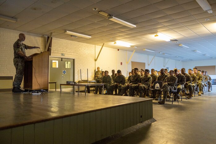 British Royal Marine Color Sgt. Christopher McHale, a unit platoon weapon class 1 with 43 Commando Fleet Protection Group Royal Marines, instructs U.S. Marines with Marine Corps Security Force Regiment the basic sequence of events for Tartan Eagle phase II, Otterburn Training Camp, Europe, Oct. 24, 2022. U.S. Marines trained to effectively fire the Royal Marines annual combat marksmanship training test, close-quarters battle ranges and learn technical field skills while overseas with 43 Cdo RM. Exercise Tartan Eagle is an annual bilateral training exercise for the U.S. Marines and British Royal Marines with 43 Cdo RM to travel to each command’s training facilities to exchange tactics, techniques and procedures in fixed site security.