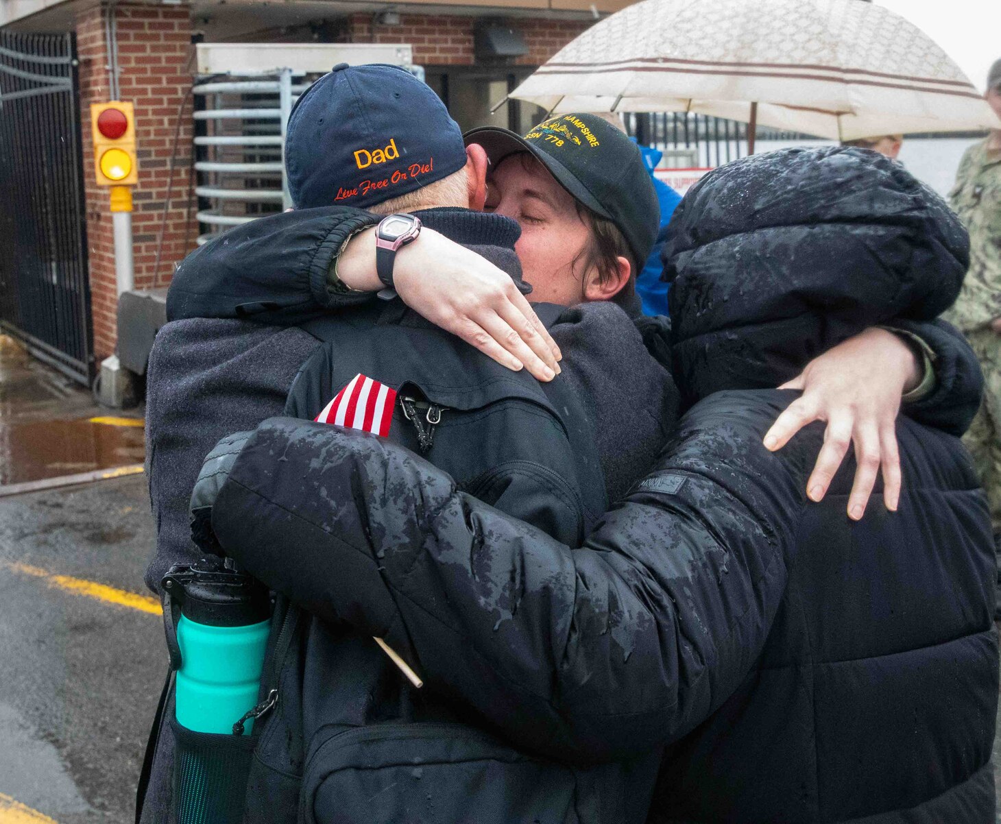 Lt. Erin Ford, the navigator onboard the Virginia-class fast-attack submarine USS New Hampshire (SSN 778), embraces her parents during the boat's homecoming at Naval Station Norfolk, Jan. 17, 2023.