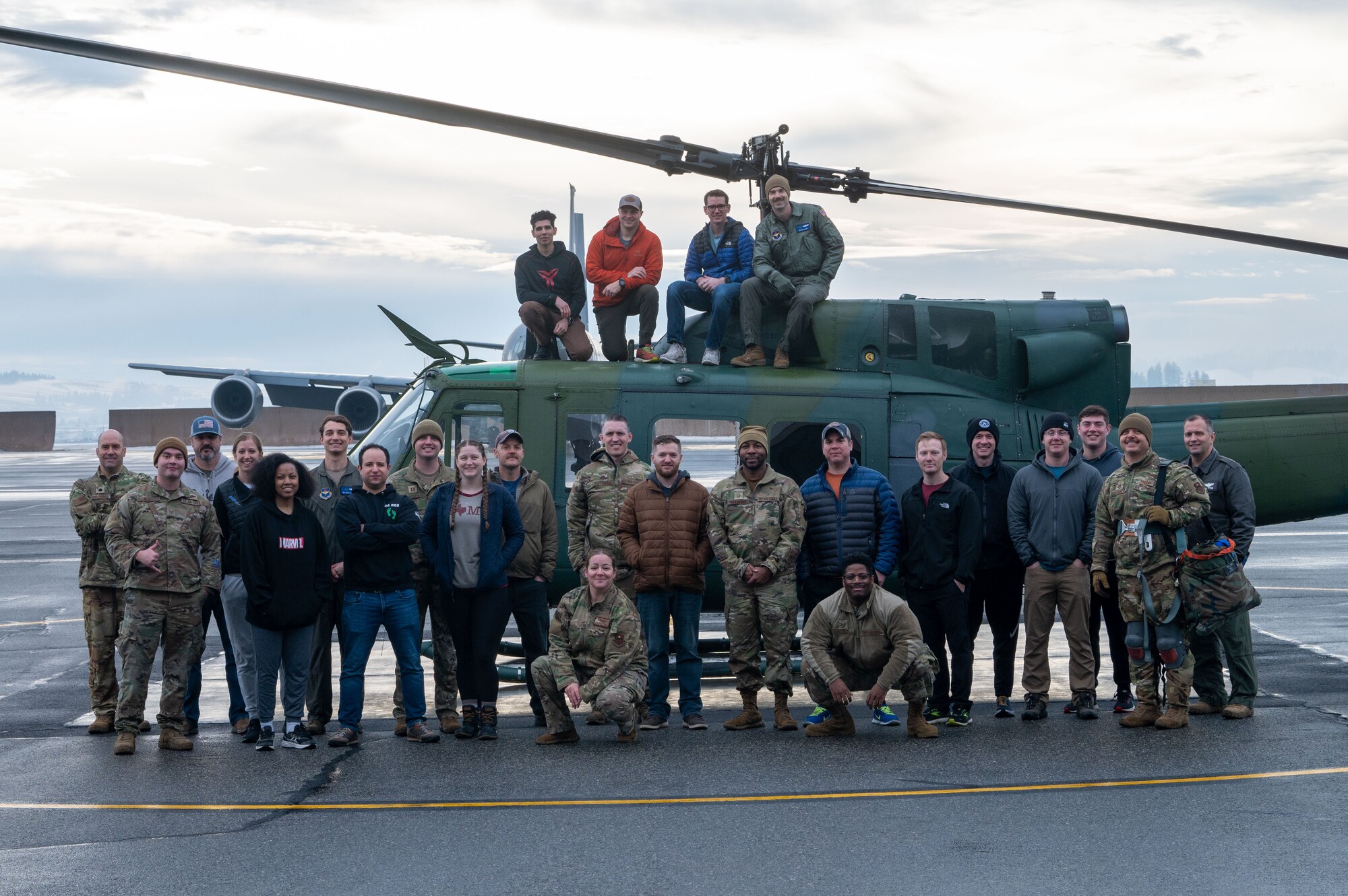 U.S. Air Force Airmen and civilians from the 36th Rescue Squadron pose with UH-1N Huey number 6648 after its completion of 20,000 flight hours at Fairchild Air Force Base, Washington, Jan. 13, 2023. The 36th RQS also has the most diverse mission set of any singular UH-1N unit in the Air Force supporting the 336th Training Group’s Survival, Evasion, Resistance, and Escape (SERE) training, medical evacuation, cargo sling, water survival training and pararescue drop. (U.S. Air Force photo by Airman 1st Class Stassney Davis)