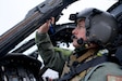COAST GUARD AIR STATION KODIAK, Alaska -- Alaska Air National Guard Maj. Tyler Seibold, 210th Rescue Squadron HH-60G Pave Hawk pilot, carries out preflight checks Jan. 12, 2023,  during joint training with the Coast Guard's Maritime Security Response Team West. The HH-60 is the Defense Department's only dedicated rotary-wing combat search and rescue platform. (Alaska Air National Guard photo by David Bedard)