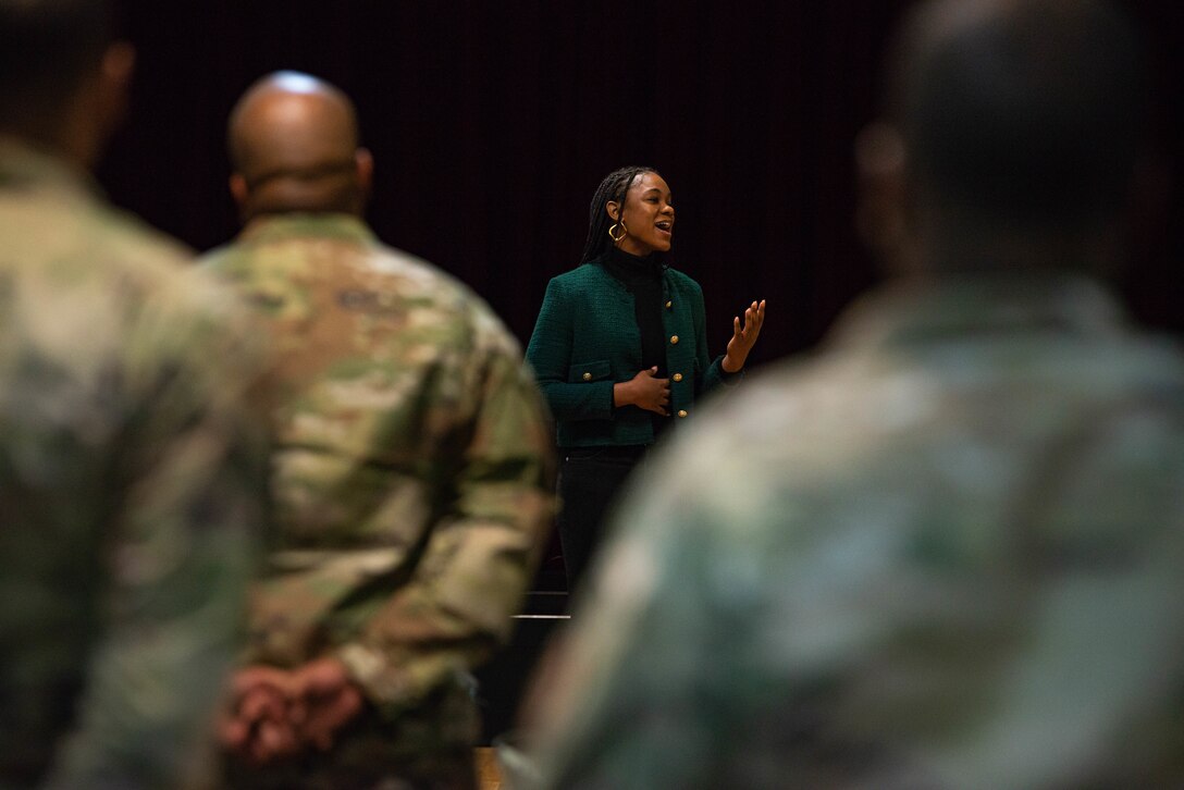 U.S. Army Soldier sings with attendants