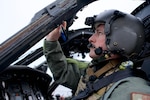 COAST GUARD AIR STATION KODIAK, Alaska -- Alaska Air National Guard Maj. Tyler Seibold, 210th Rescue Squadron HH-60G Pave Hawk pilot, carries out preflight checks Jan. 12, 2023,  during joint training with the Coast Guard's Maritime Security Response Team West. The HH-60 is the Defense Department's only dedicated rotary-wing combat search and rescue platform. (Alaska Air National Guard photo by David Bedard)