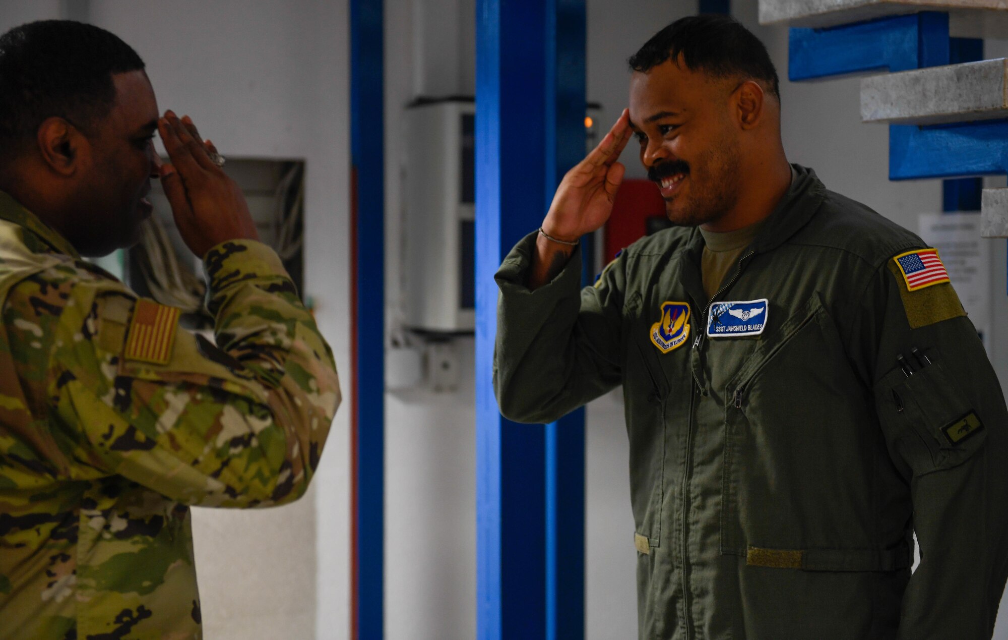 U.S. Air Force Staff Sgt. Jashield Blades, 37th Airlift Squadron noncommissioned officer in charge of loadmaster development, salutes after being coined by Brig. Gen. Otis C. Jones, 86th Airlift Wing commander at Ramstein Air Base, Germany, Jan. 12, 2023. Blades was announced as Airlifter of the Week for displaying exceptional leadership in his first six months on station.