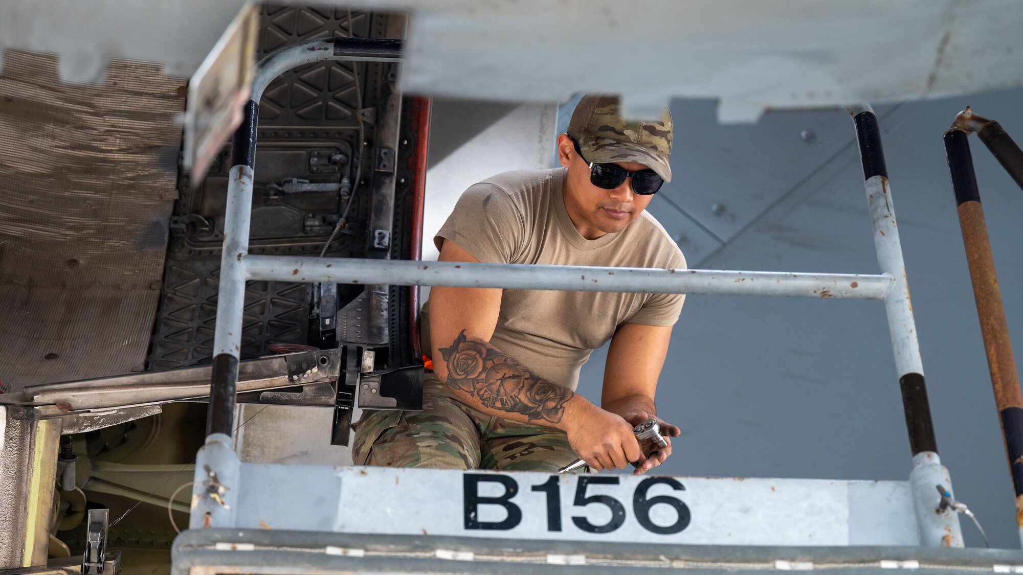 A photo of a US Airman on a lift performing maintenance on a C-17
