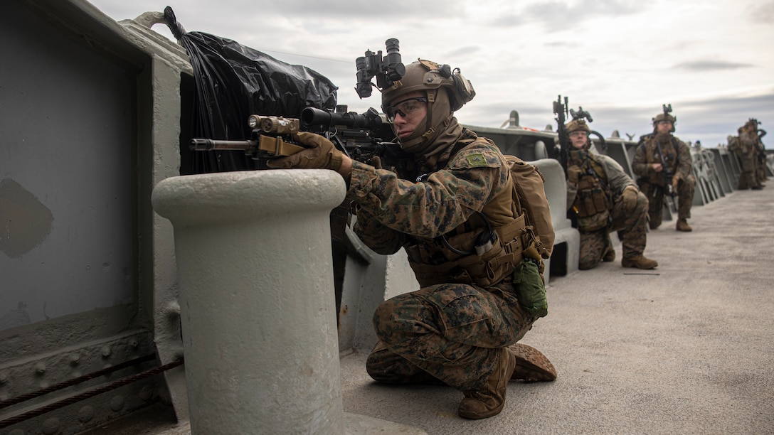 A U.S. Marine with Battalion Landing Team 1/6, 26th Marine Expeditionary Unit (MEU), establish security during a Visit, Board, Search, and Seizure (VBSS) course at Fort Eustis, Virginia, Jan. 12, 2023. Marines with the MSPF and BLT 1/6 conducted boat assault force operations to further advance their qualifications to conduct VBSS operations during their upcoming deployment with the 26th MEU. The VBSS course is designed by Expeditionary Operations Training Group to train MSPF, BLT 1/6, and supporting enablers across the Marine Air Ground Task Force to conduct Maritime Interception Operations in preparation for the Amphibious Ready Group/Marine Expeditionary Unit (ARG/MEU) deployment. (U.S. Marine Corps photo by Cpl. Matthew Romonoyske-Bean)