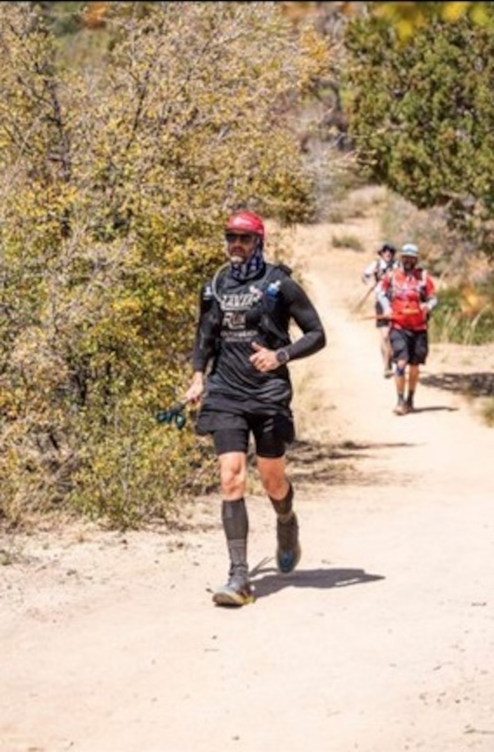 Petty Officer 3rd Class Nathaniel Dirvin runs in the Cocodona 250 race through Black Canyon City and into the Bradshaw Mountains in Arizona in 2022.