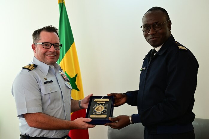 U.S. Coast Guard Cmdr. Corey Kerns, commanding officer of USCGC Spencer (WMEC 905), is presented a plaque by Capt. Karim Mara, Senegalese Navy deputy chief of staff, in Dakar, Senegal, Jan. 17, 2023. Spencer is on a scheduled deployment in the U.S. Naval Forces Africa area of responsibility, employed by the U.S. Sixth Fleet, to carry out joint training, exercises, and maritime security operations alongside AFRICOM partners in support of U.S. interests abroad, regional partnerships, and to strengthen international maritime governance. (U.S. Coast Guard photo by Petty Officer 3rd Class Mikaela McGee)