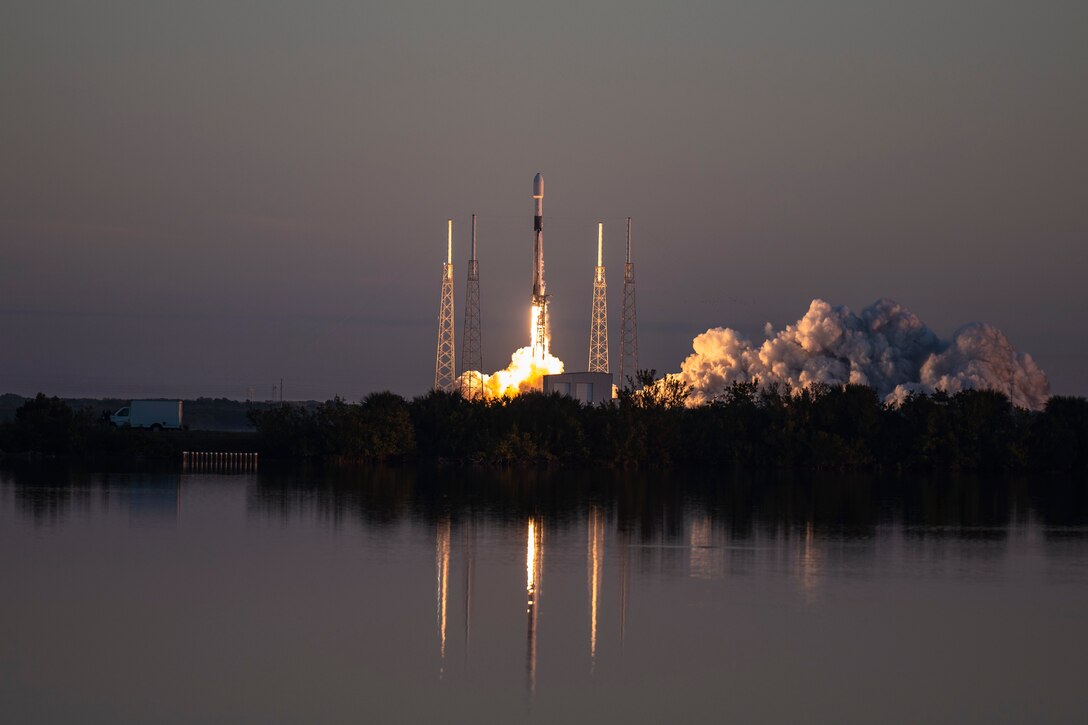 A rocket launches at night.