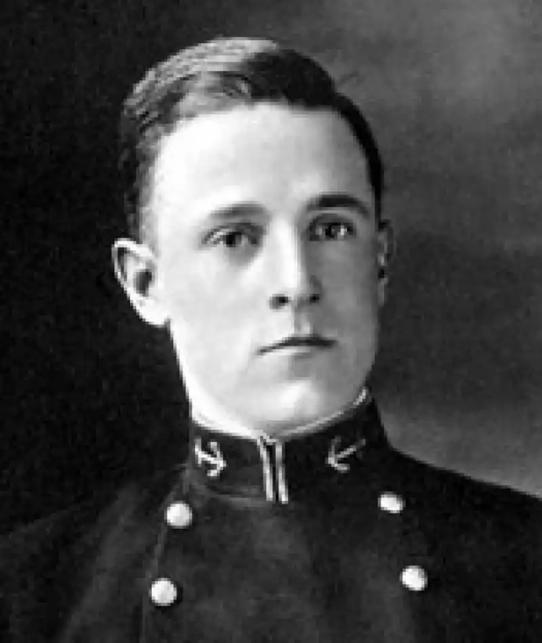 A man in dress uniform poses for a photo.