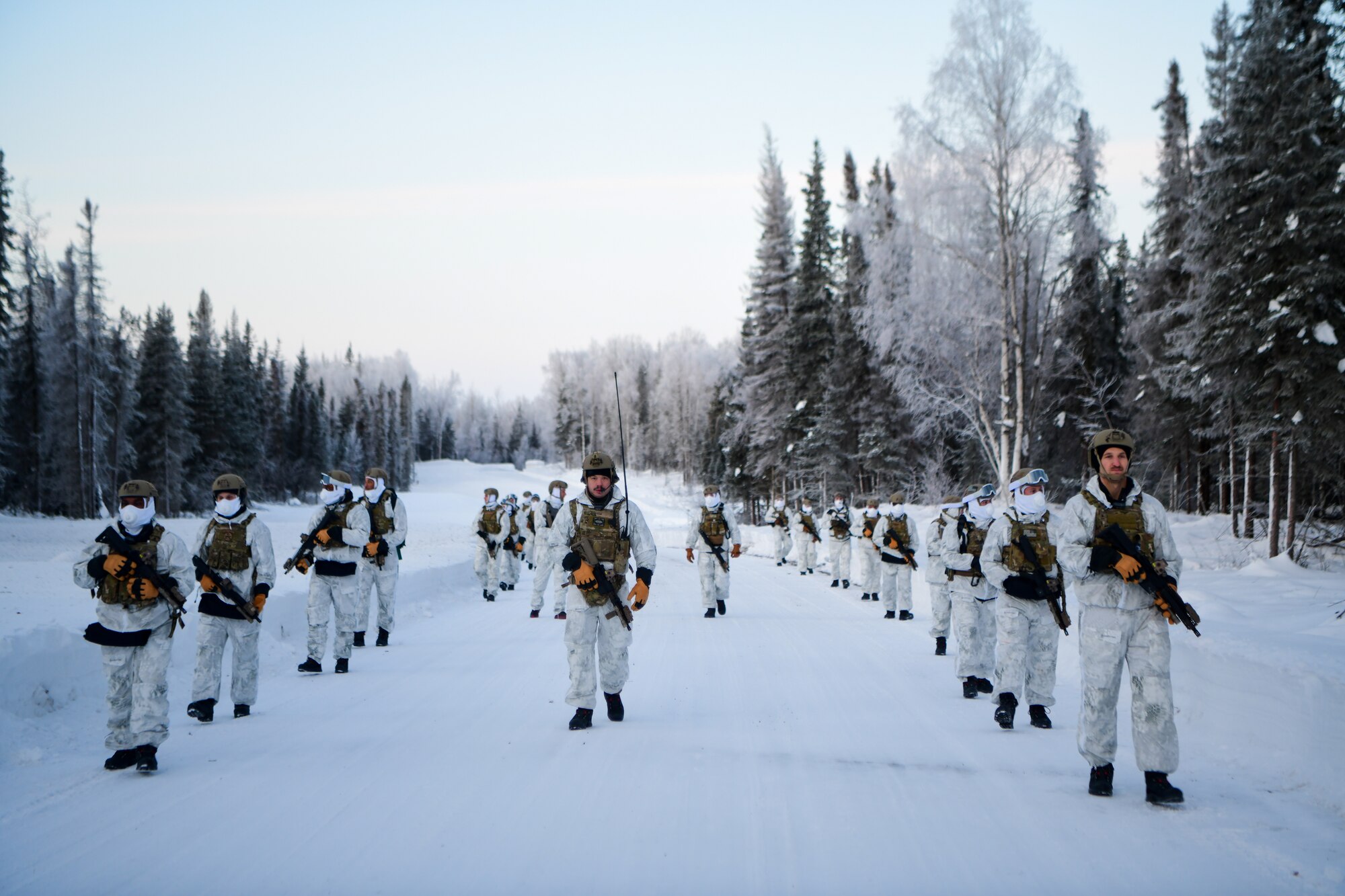 Airmen conduct a simulated combat training in extreme-cold conditions