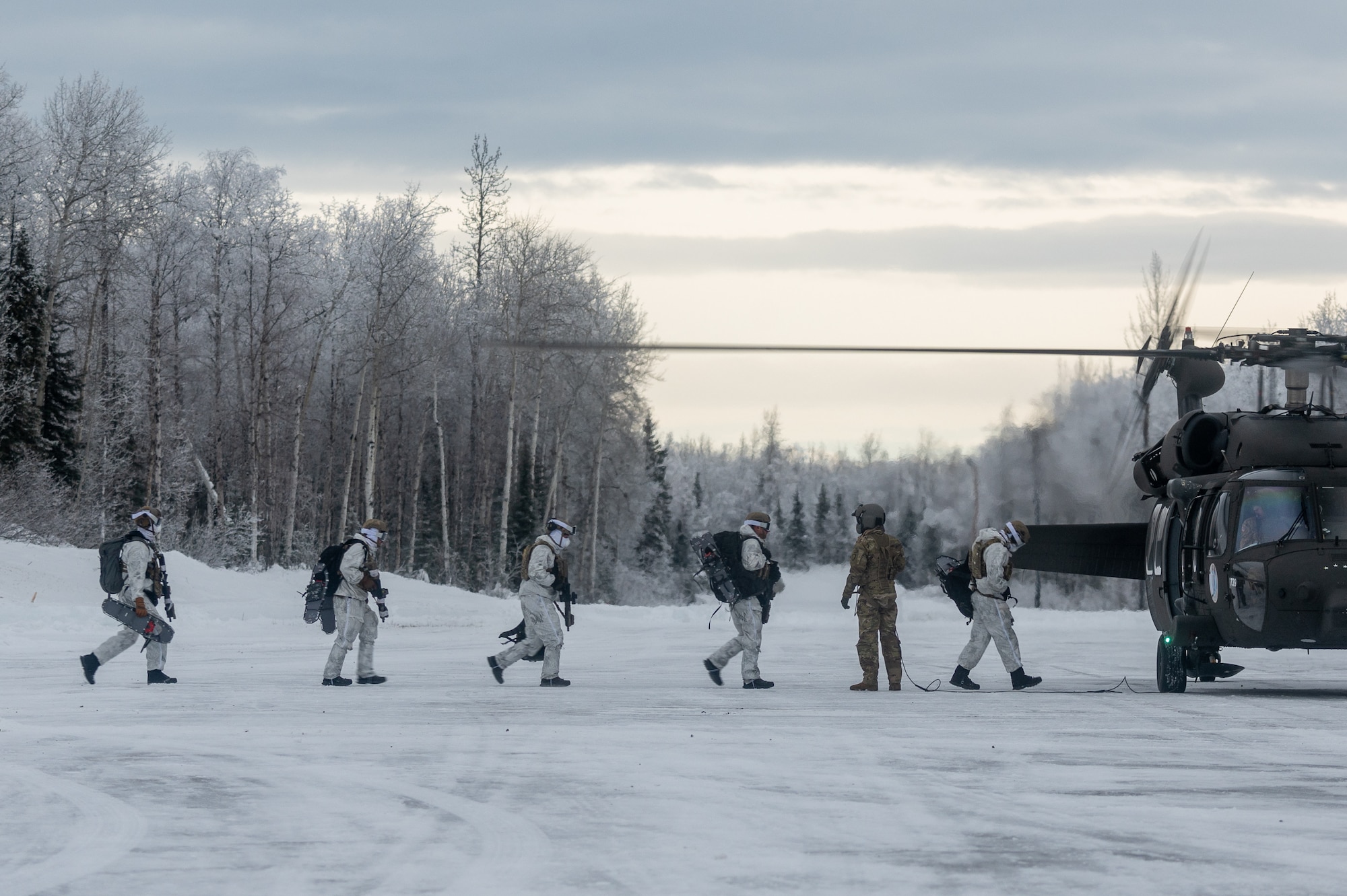 Airmen conduct a simulated combat training in extreme-cold conditions