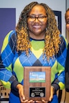 Sara Brown shows the plaque she earned for being named Walter Reed National Military Medical Center’s (WRNMMC) Junior Civilian of the Year (CoY) – Administrative. Brown serves as payroll lead in the Budget/Payroll Department at WRNMMC. She received the award during the January 2022 WRNMMC Director's Town Hall Meeting, Jan. 10.