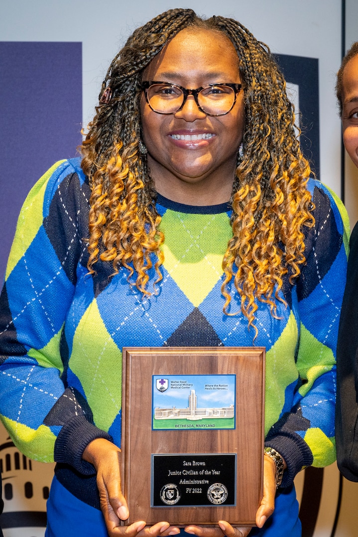 Sara Brown shows the plaque she earned for being named Walter Reed National Military Medical Center’s (WRNMMC) Junior Civilian of the Year (CoY) – Administrative. Brown serves as payroll lead in the Budget/Payroll Department at WRNMMC. She received the award during the January 2022 WRNMMC Director's Town Hall Meeting, Jan. 10.