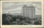 A WWII era postcard shows the Percy Jones Army Hospital building. The image is in black and white. in the foreground are trees that hide part of the six story building but the tower addition stands tall with 15 floors.