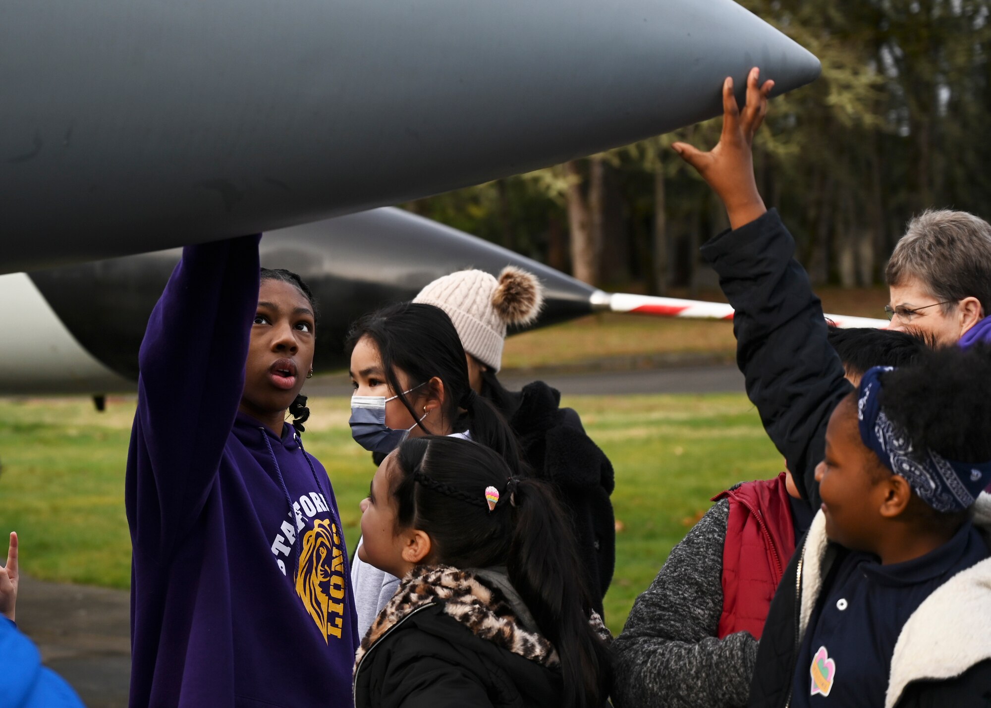 Students from Stafford Elementary School, Tacoma, tour Heritage Hill Airpark during an Aviation Inspiration and Mentorship (AIM) event at Joint Base Lewis-McChord, Washington, Jan. 17, 2023. AIM is a community outreach program that is designed to inform, influence and inspire the next generation of Air Force aviators. (U.S. Air Force photo by Senior Airman Callie Norton)