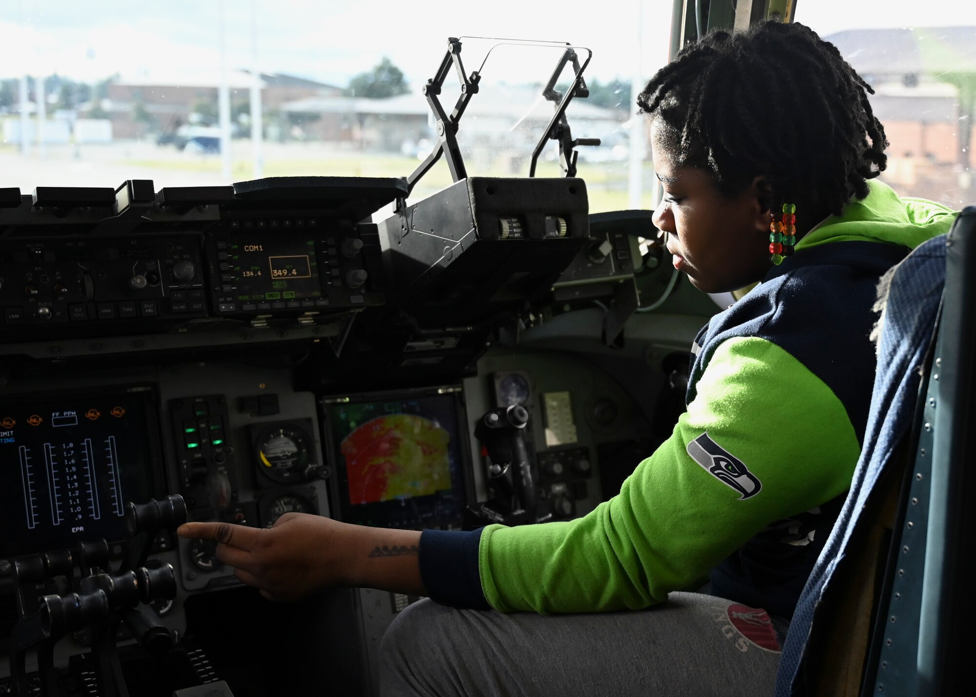 A student from Stafford Elementary School, Tacoma, explores the cockpit of a C-17 Globemaster III assigned to the 62d Airlift Wing during an Aviation Inspiration and Mentorship (AIM) event at Joint Base Lewis-McChord, Washington, Jan. 17, 2023. AIM is a community outreach program that is designed to inform, influence and inspire the next generation of Air Force aviators. (U.S. Air Force photo by Senior Airman Callie Norton)