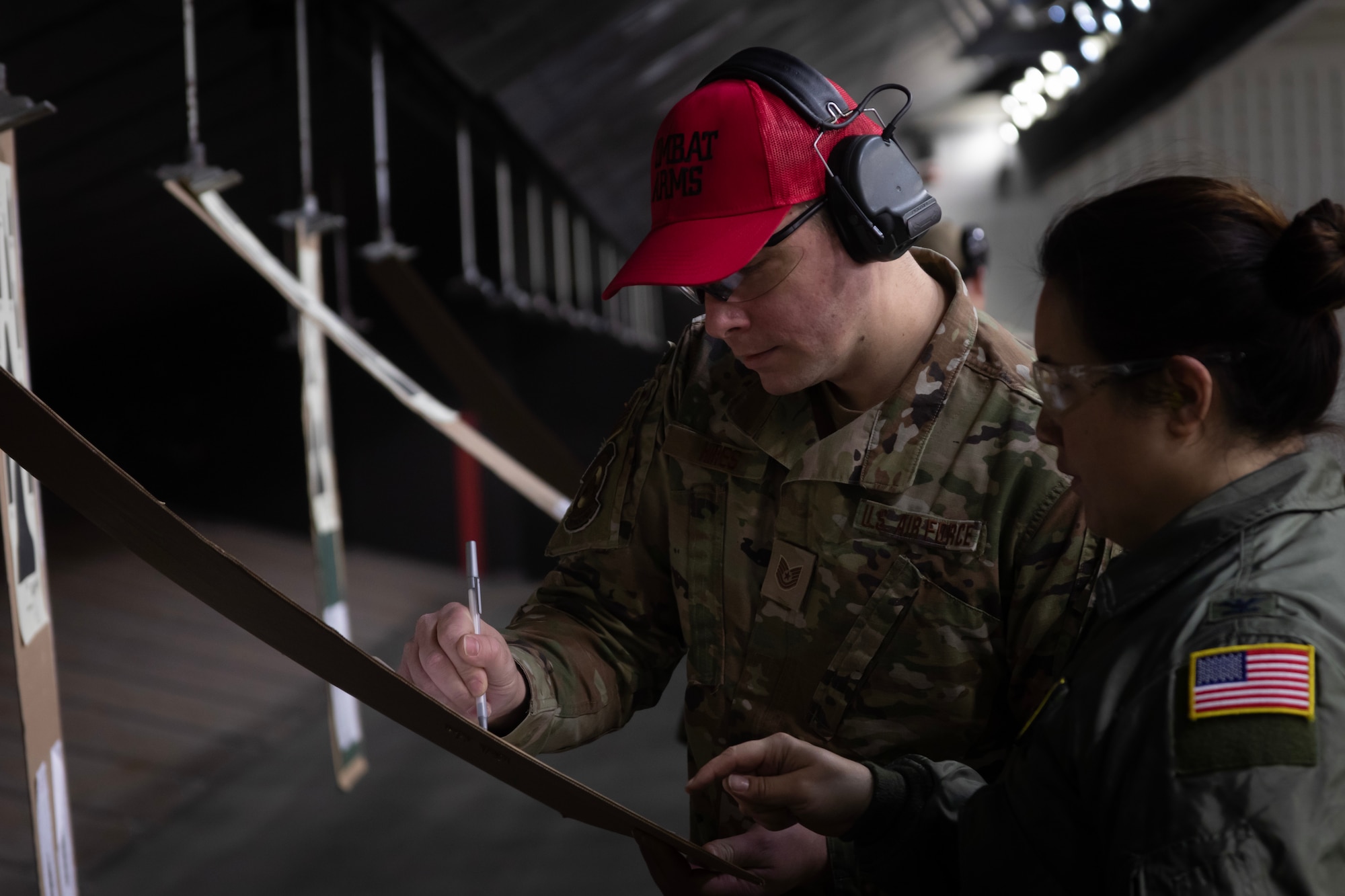 U.S. Air Force Tech. Sgt. Zachary Hires, a combat arms instructor with the 177th Security Forces Squadron, left, assists Col. Jade Spurgeon with sight adjustments during M4 carbine qualification at a shooting range at the FAA William J. Hughes Technical Center, Egg Harbor Township, New Jersey, Jan. 8, 2023.