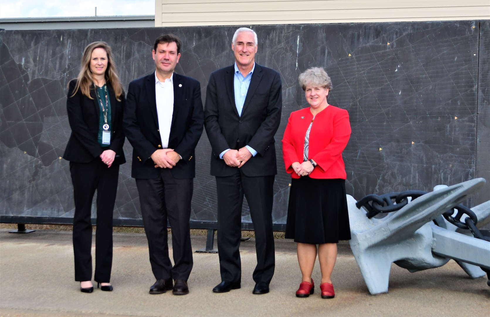 IMAGE: Naval Surface Warfare Center Dahlgren Division (NSWCDD) Chief Technology Officer Jennifer Clift, SSTM, stands alongside National Science Foundation officials, Dr. Jesus Soriano-Molla, NSF Program Director, Dr. Barry Johnson, Translation Impacts (TI) Division Program Director, and Dr. Carol Bessel, TI Division section head, in front of the Brass Map while on a tour of the Potomac River Test Range. The group visited NSWCDD Jan. 5 for a tour of facilities and labs and to attend technical briefings of various warfare systems.