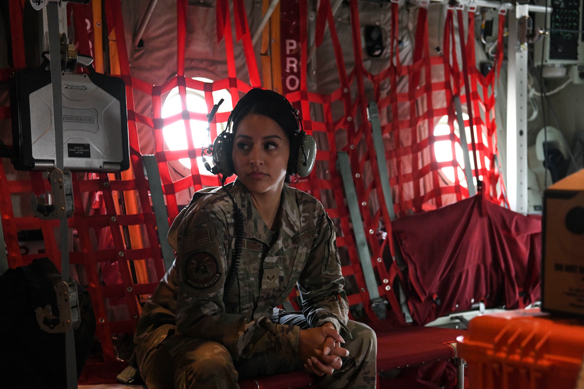 N.Y. Air National Guard 106th Rescue Wing Senior Airman Jocelyn Tapia-Puma, a 102nd Rescue Squadron aviation resource manager, looks toward the back of an HC-130J Combat King II search and rescue aircraft, May 20, 2022. Tapia-Puma was asked to join a search and rescue mission as a Spanish interpreter between members of the 102nd Rescue Squadron and passengers on-board a 32-foot vessel 1,200 miles from the coast of Long Island, who had a passenger severely burned. (U.S. Air National Guard photo by SSgt. Daniel H. Farrell)