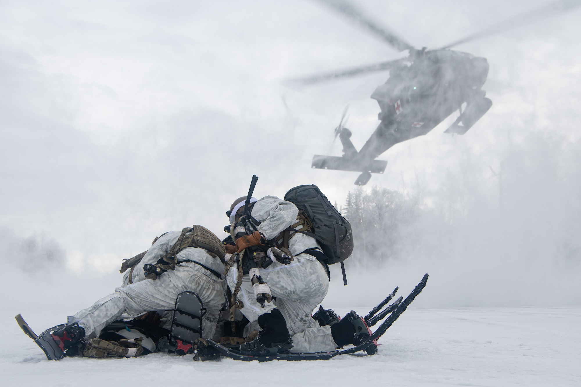 Airmen conduct a simulated combat training in extreme-cold conditions