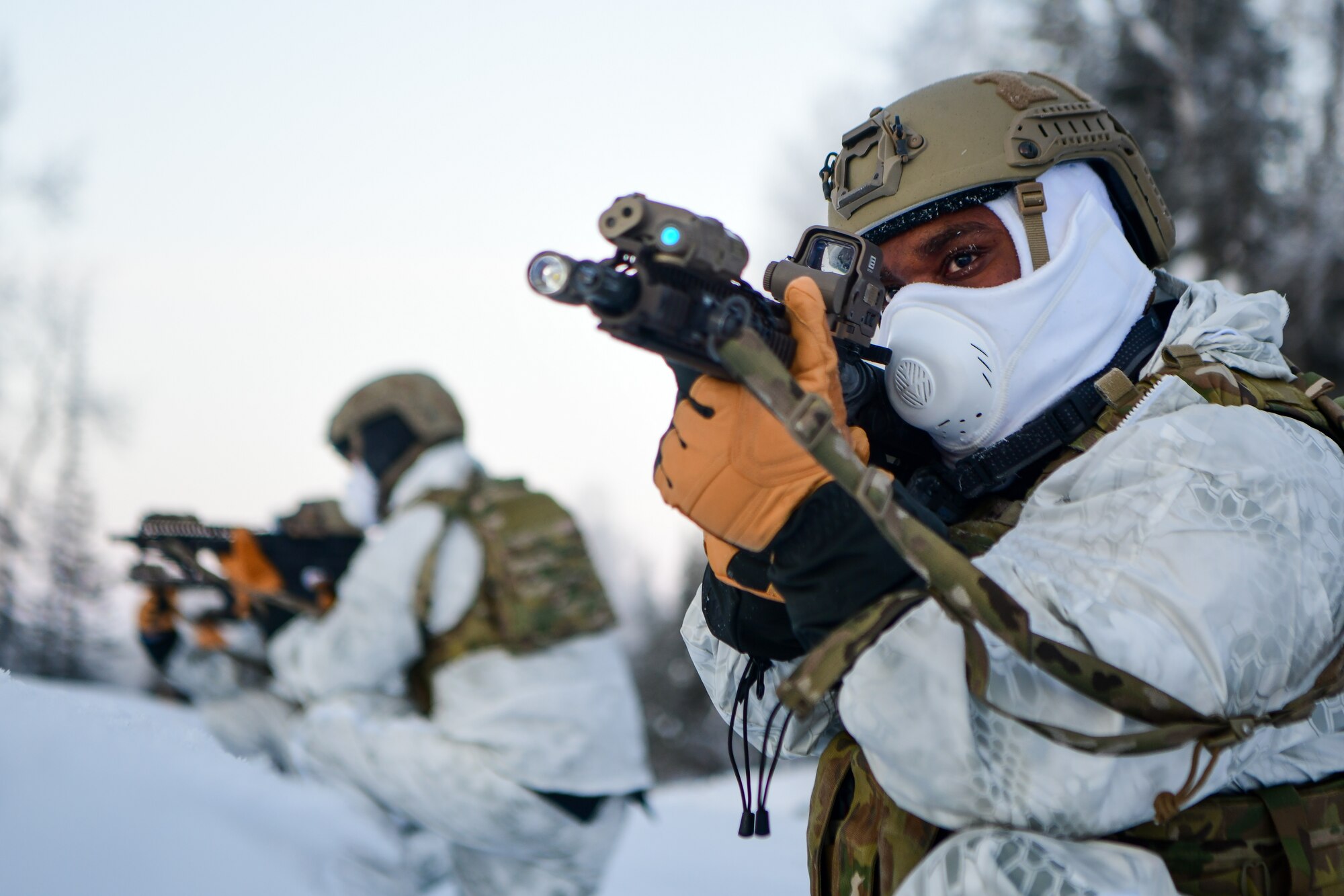 Airmen conduct a simulated combat training in extreme-cold conditions