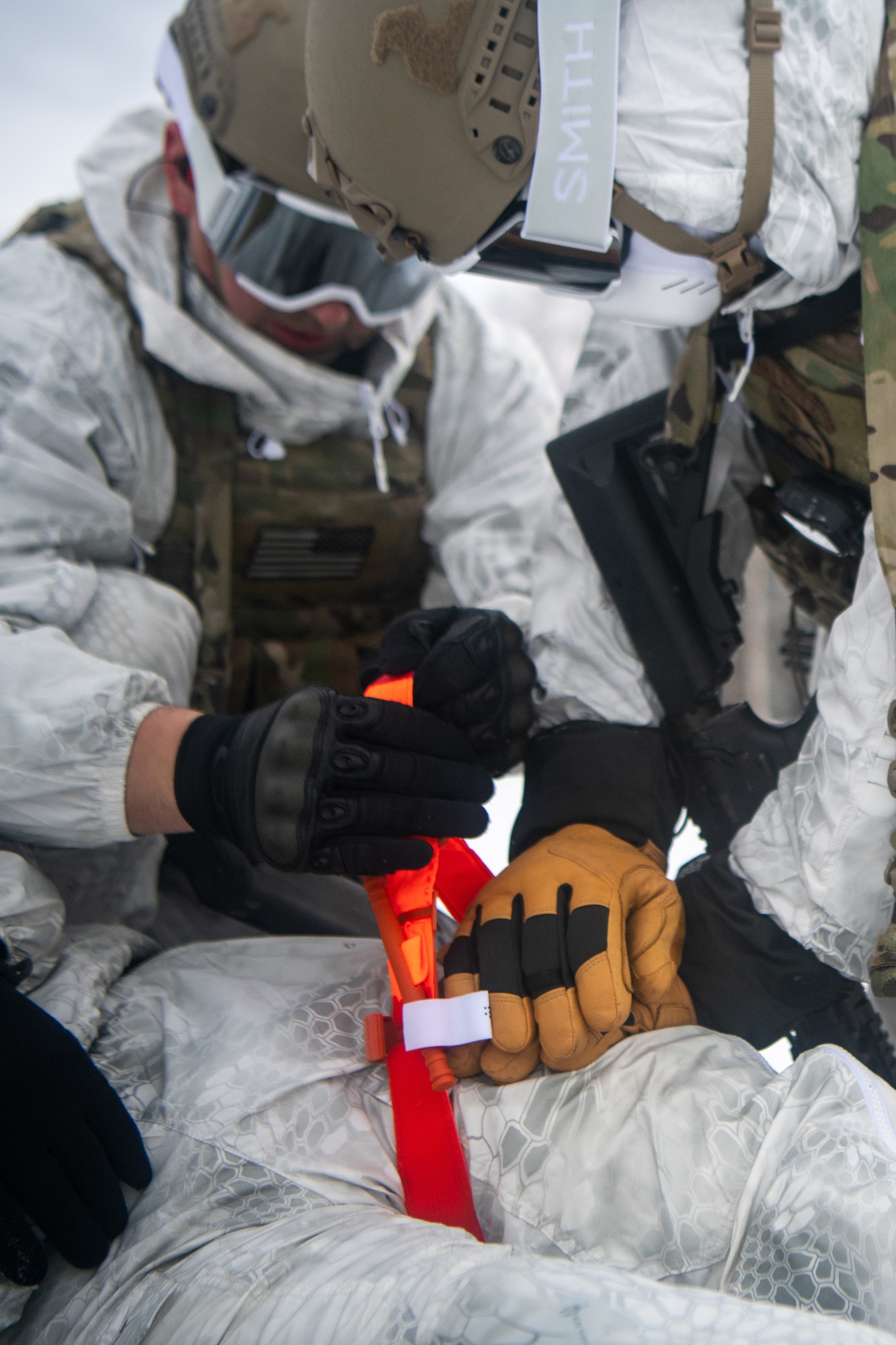 Airmen conduct a simulated combat training in extreme-cold conditions