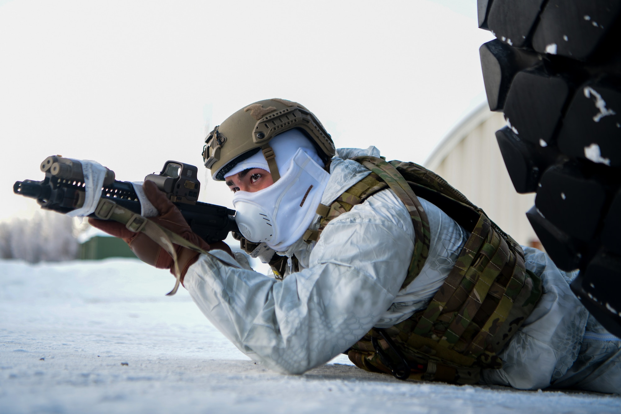 Airmen conduct a simulated combat training in extreme-cold conditions