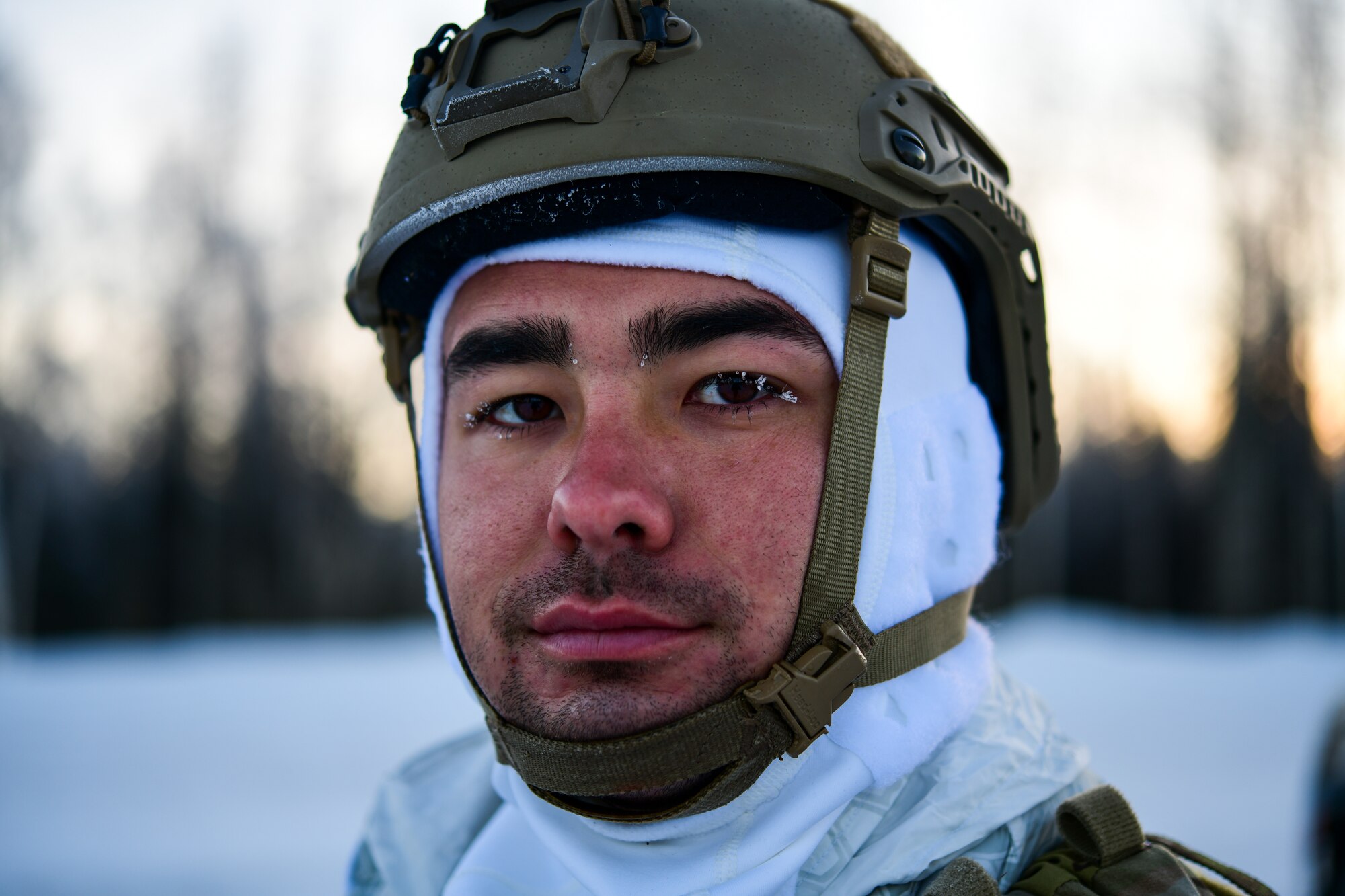 Airmen conduct a simulated combat training in extreme-cold conditions